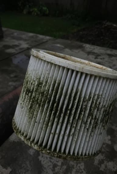 Fictional customer photo of a dirty cartridge filter